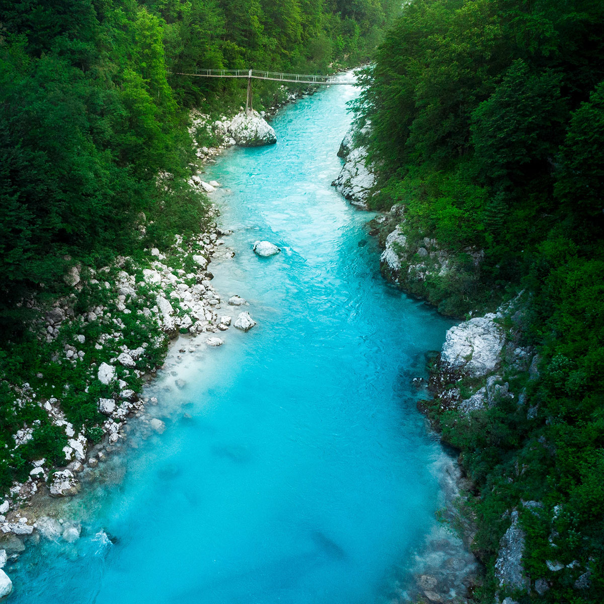 blue river with a bridge crossing